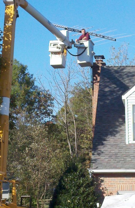 Servicing a TV antenna with our 56 foot bucket truck